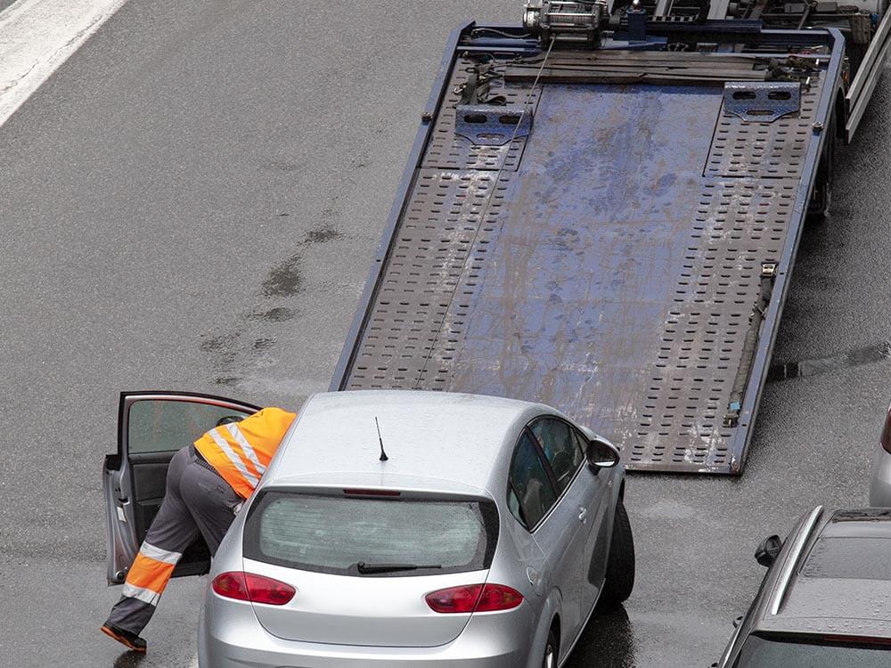 Broken down car on the street read to load to the platform