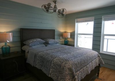 Carrs Landing primary bedroom with wood treatment walls