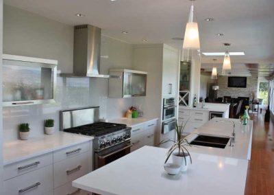 LoneWolf Homes East Kel kitchen with crisp white cabinetry and quartz counters