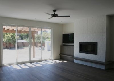 LoneWolf Homes Rayburn living room walkout with custom hearth, tile surrounding gas fireplace