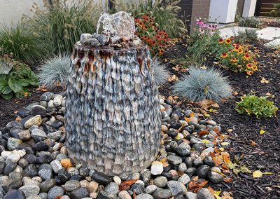 LoneWolf Homes fountain rocks and mulch hardscaping