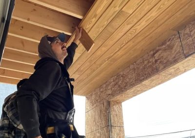 North End carpenter installing wood soffit