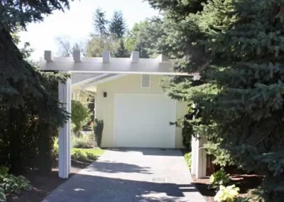 LoneWolf Homes Mission bungalow garage addition with paver stone driveway