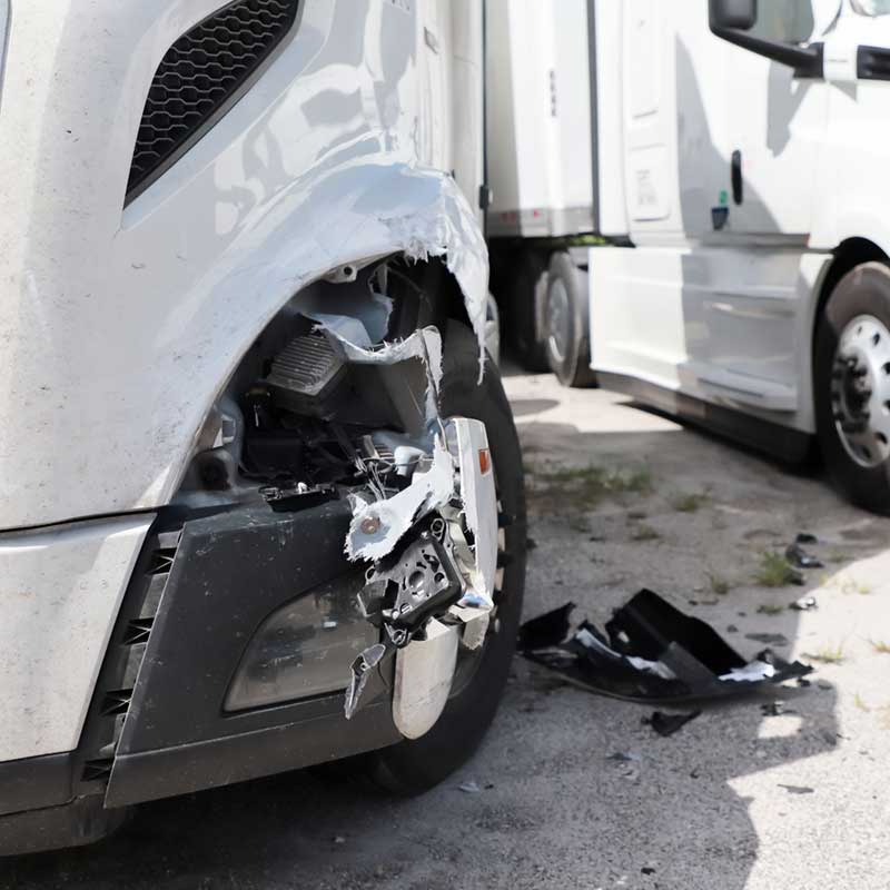 Damage closeup on white truck