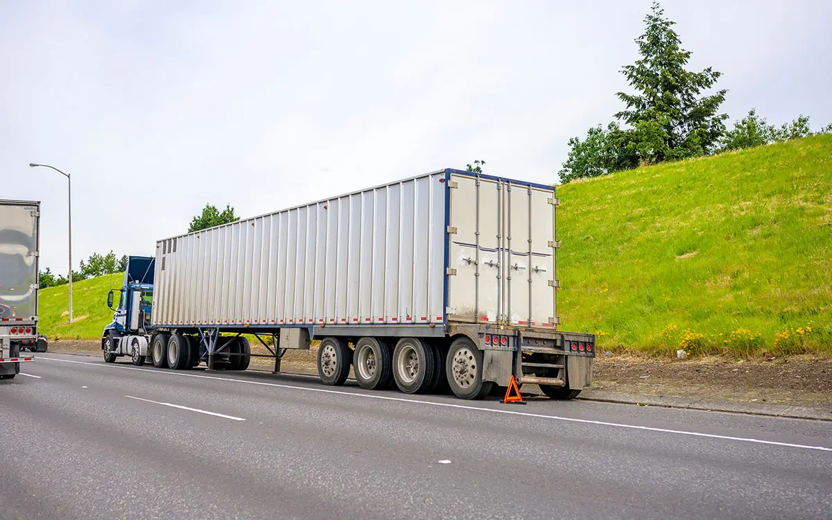 semi trailer standing broken on the road